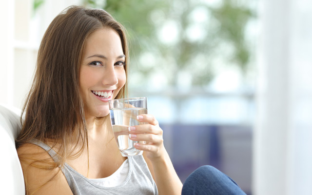 Happy lady drinking water